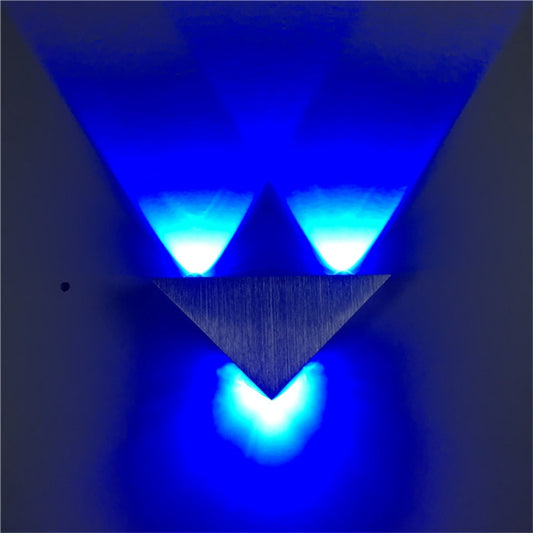 Triangular aluminum wall lamp showing blue LED light beams from two fixtures