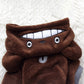 Brown chinchilla fleece dog coat close-up of hood and white snout patch.