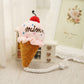Pink plush ice cream cone squeaky pet toy with red cherry top and white rope legs