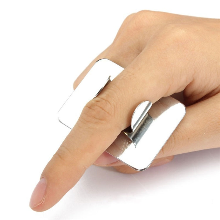 Small square stainless steel cosmetic mixing palette held in hand