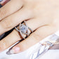 Rose gold and silver-tone cross zircon ring on hand with round center stone