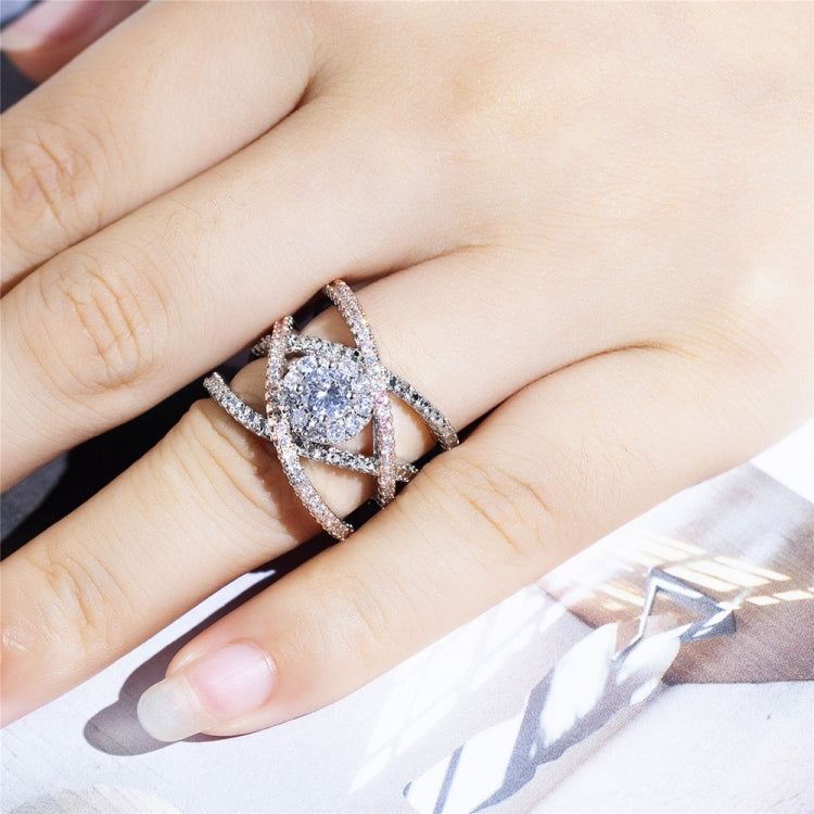 Rose gold and silver-tone cross zircon ring on hand with round center stone