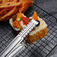 Stainless steel food clip gripping food with serrated gripping pads