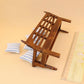 Mini wooden bench for dollhouse with three blue-and-white striped pillows