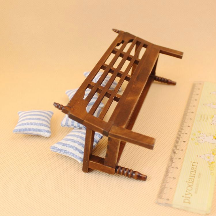 Mini wooden bench for dollhouse with three blue-and-white striped pillows