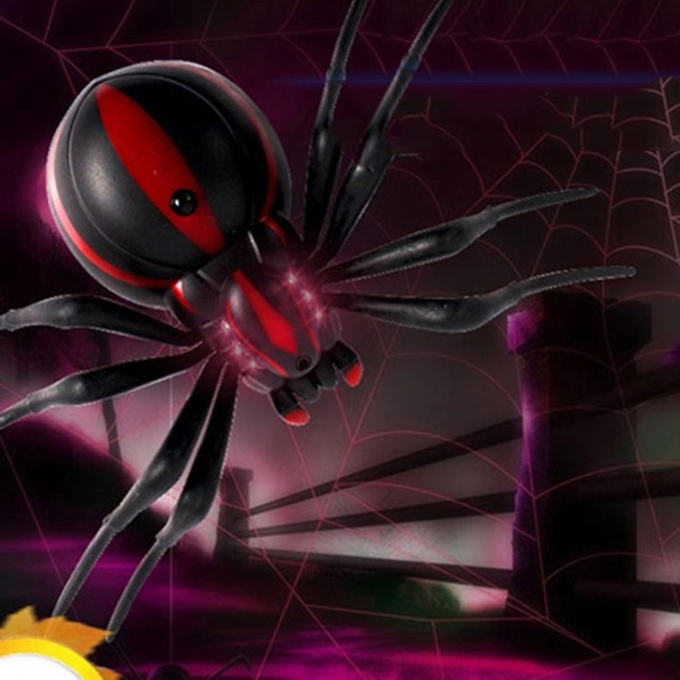 Infrared remote control spider toy close-up, black and red with glowing lights