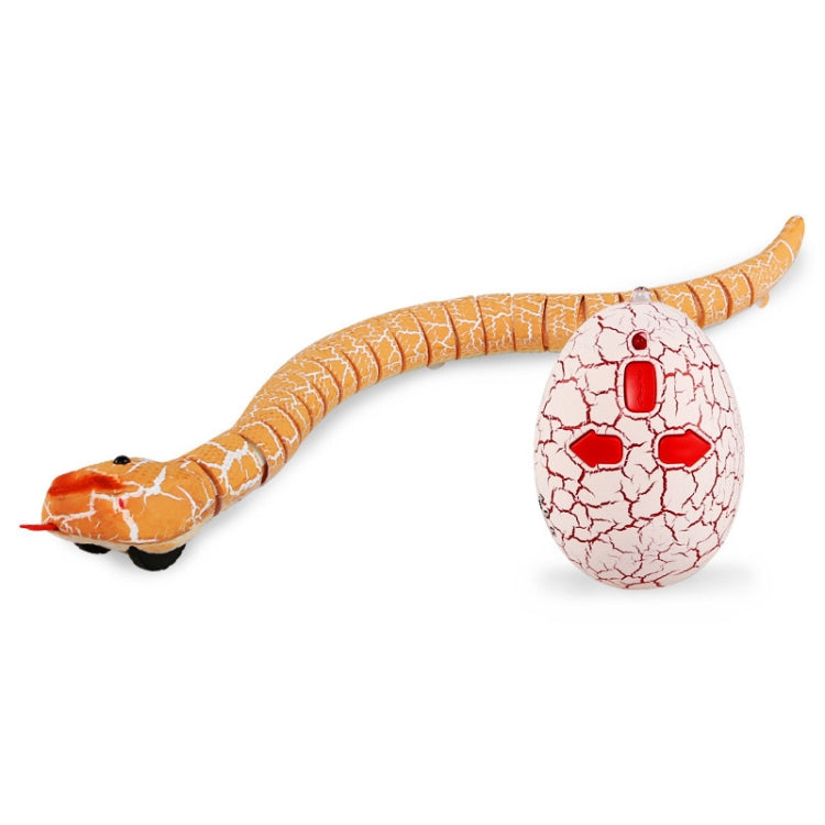 Orange remote-control snake toy with looped body and white egg controller, side view