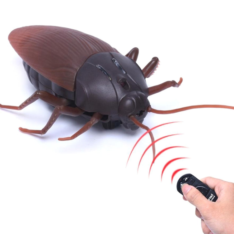 Remote-control cockroach toy with brown wings and dark body, remote control with infrared lines