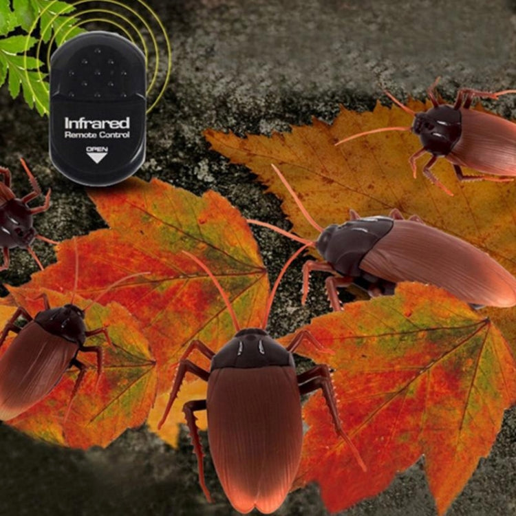 Remote-control cockroach toy on leaves with infrared remote control, brown wings and dark body