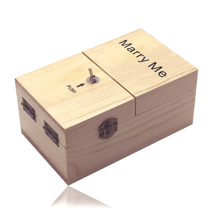 Light wood stress-relief gift box with “Marry Me” lid text and metal push knob