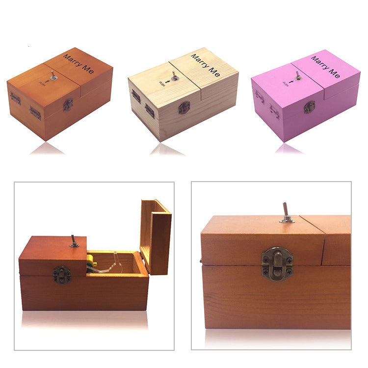 Three wooden “Marry Me” stress-relief boxes in orange, light wood, and pink