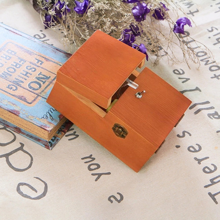 Orange wooden anti-stress box toy with open hinged lids showing hollow interior.