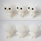 Three white bear doll figurines shown from different angles, with black eyes and pink blush