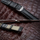 Black lizard-texture leather watch strap with silver buckle and light stitch trim.