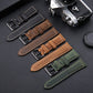 Assorted leather watch bands with metal buckles and stitched perforations.