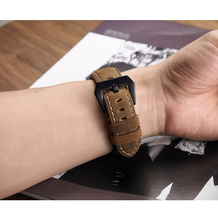 24mm brown leather watch band with black buckle on a wrist