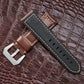 Dark brown leather watch band with silver-tone buckle and contrast stitching