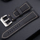 Black leather watch band with silver-tone buckle and cream edge stitching