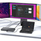 Handheld gaming PC with keyboard controls on desk beside monitors, black