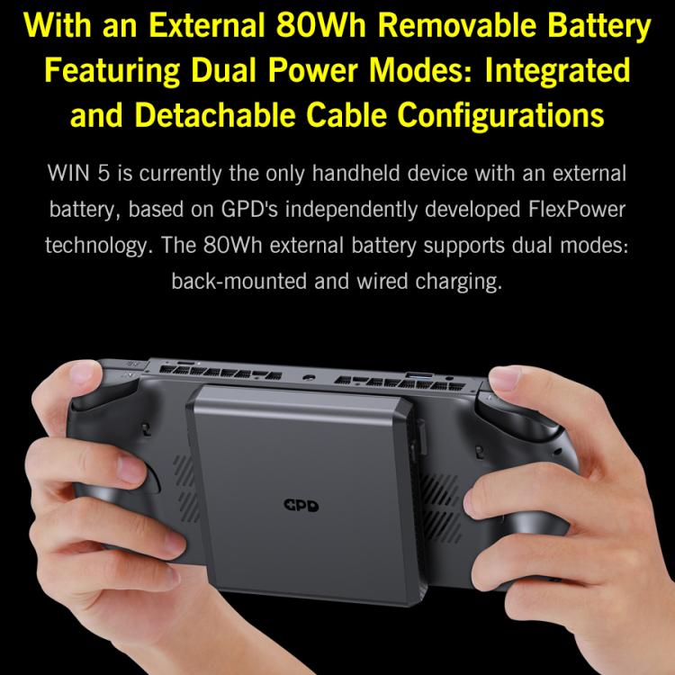 Handheld game console held in hands, with external battery pack on back