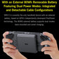 Handheld game console held in hands, dark gray body with rear battery module