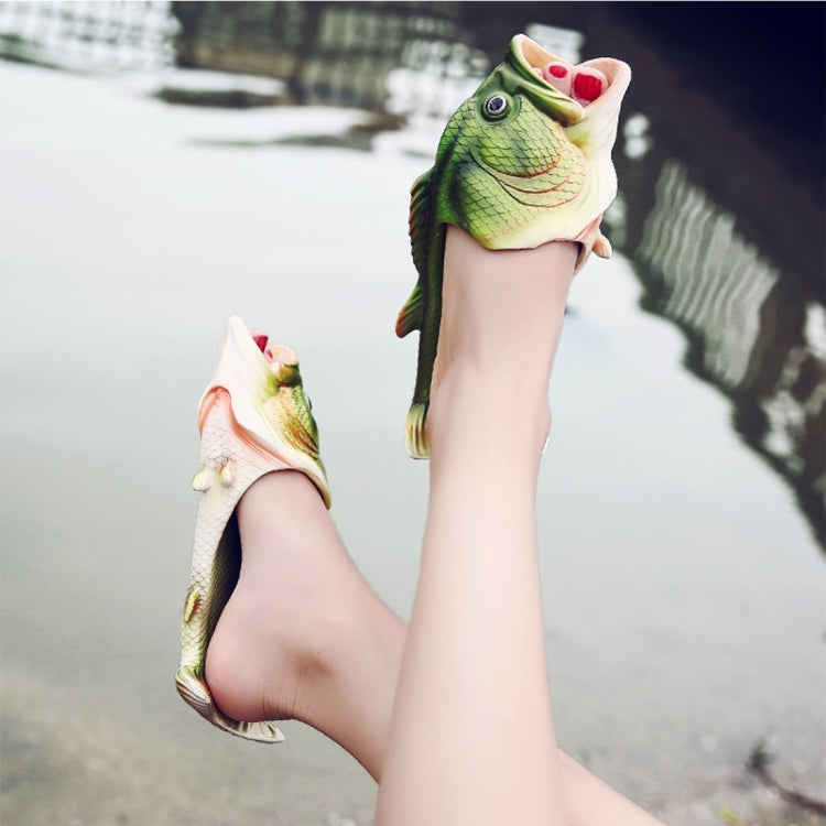 Green fish-shaped EVA kids’ beach sandals on feet with open toes and fin straps