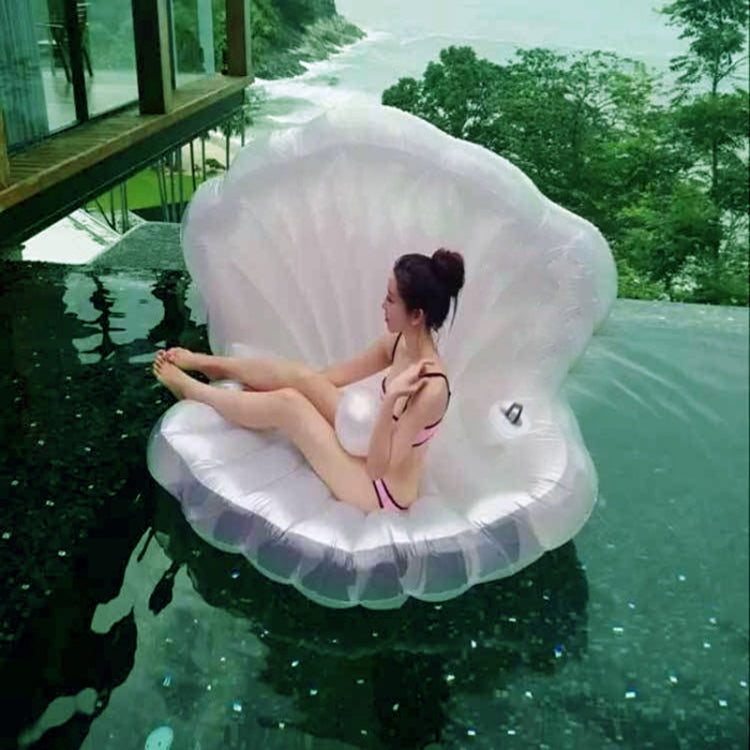 White scallop-shaped inflatable floating mat in a pool with umbrella pool cover