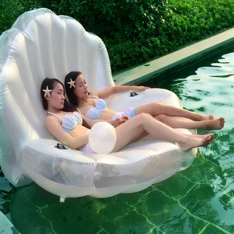 White scallop-shaped inflatable floating mat for two people in a pool