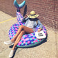 Inflatable mermaid tail lounge with purple-pink scales and teal fin, open inner ring