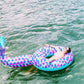 Inflatable mermaid tail pool lounge ring with purple-pink scales and teal rim