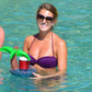 Inflatable coconut tree drink holder floating in pool with green leaves and red cups