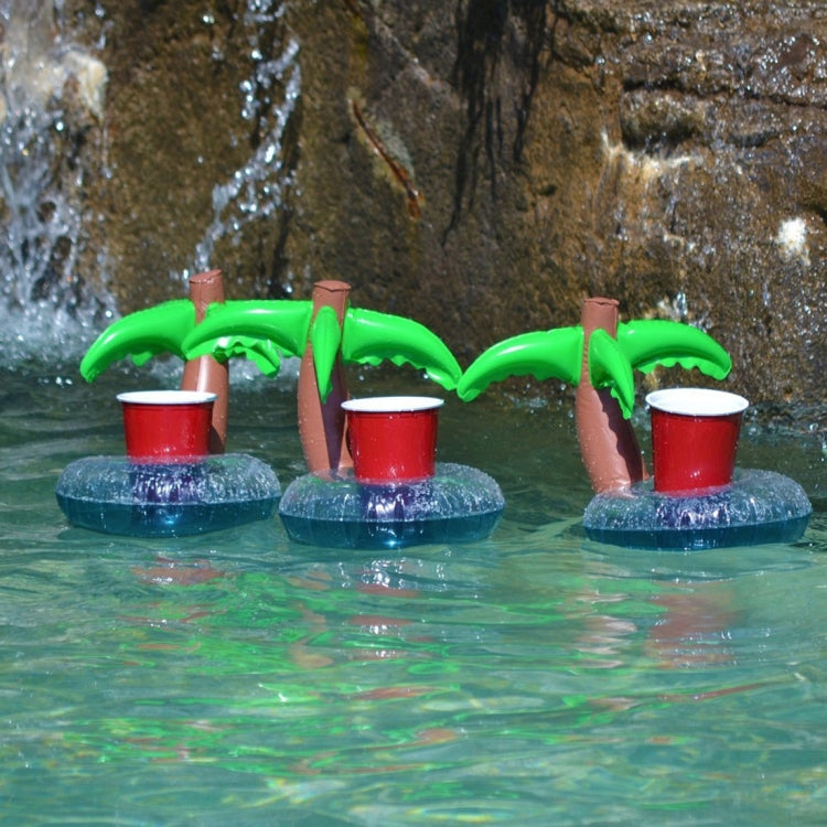 Set of inflatable coconut tree drink holders with green leaves and red cups on blue floats