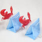 Set of red crab inflatable arm bands with light blue float sleeves, angled view