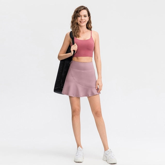 Pink athletic mini skirt with flared hem and built-in inner layer