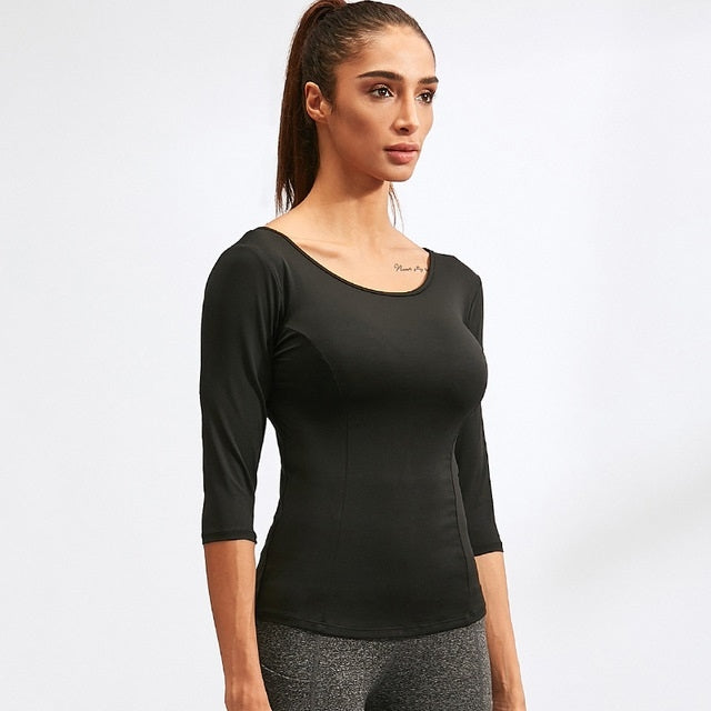 Black yoga sports top with 3/4 sleeves and wide scoop neck, fitted