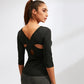 Black yoga top back view with crisscross strap and oval cutout, 3/4 sleeves