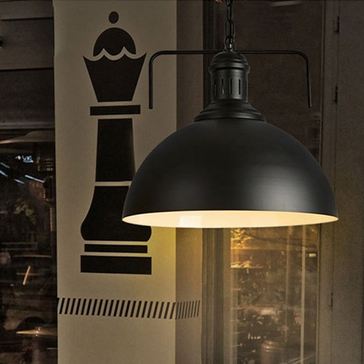Black single-head iron pendant light with dome shade and E27 socket, warm glow