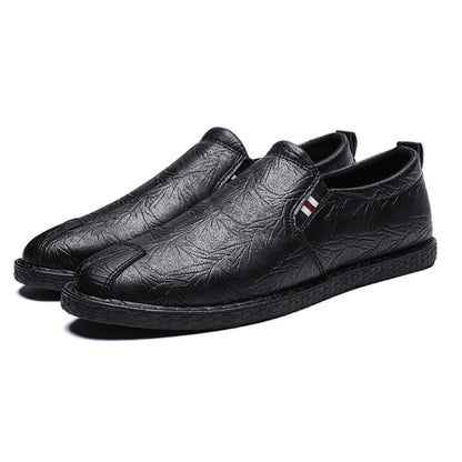Black leather slip-on shoes with round toe and textured upper