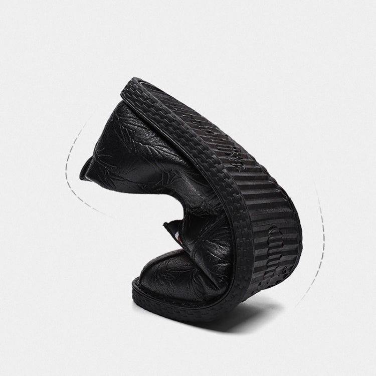 Black leather slip-on shoes with textured rubber sole and round toe