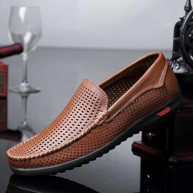 Brown perforated leather slip-on loafer with round toe, metal bit, and black tread sole.