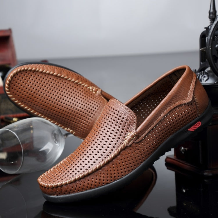 Brown perforated leather loafer close-up with round toe, metal bit, and black rubber sole.