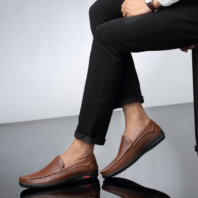Brown perforated leather slip-on loafers with round toe and black rubber sole.