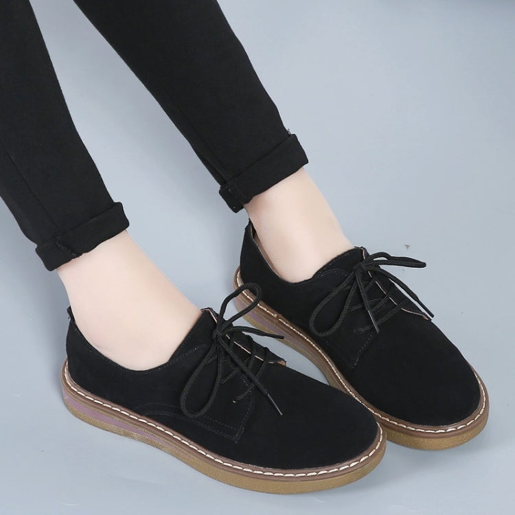 Black suede lace-up casual shoes on flat sole, tan edge trim, side view