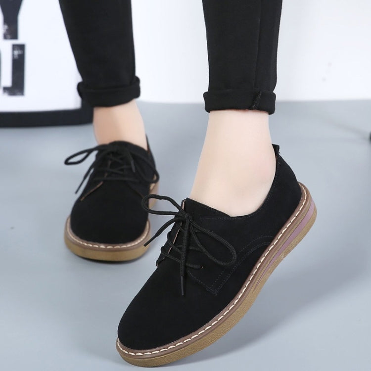 Black suede lace-up casual shoes with flat sole, tan trim, front angled view