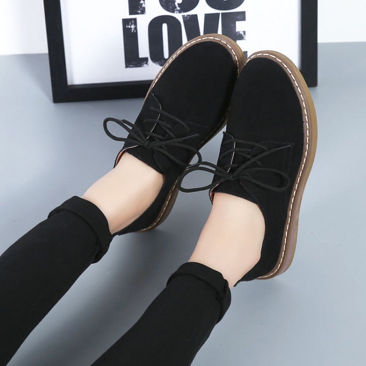 Black suede lace-up casual shoes with flat sole, tan trim, and sturdy laces