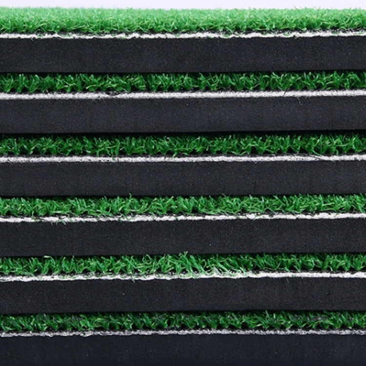 Close-up of layered mat construction: green turf on black foam padding