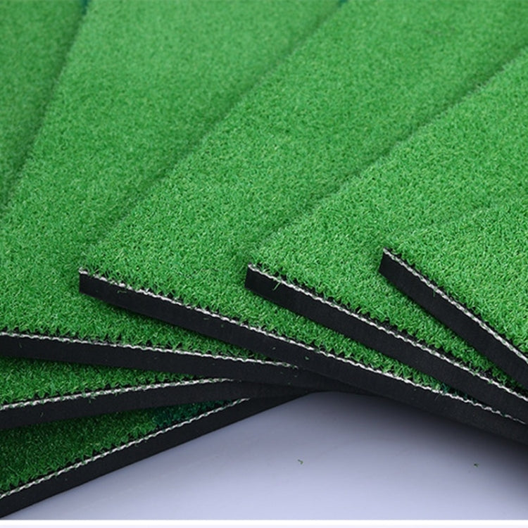 Side view of overlapping mat layers with black seams on green turf