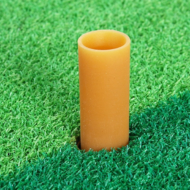 Yellow foam practice golf tee, cylindrical insert on green turf