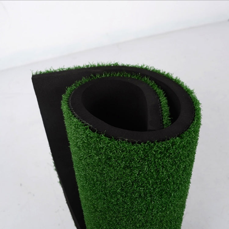Golf practice mat with green turf and circular ball target opening on dark base