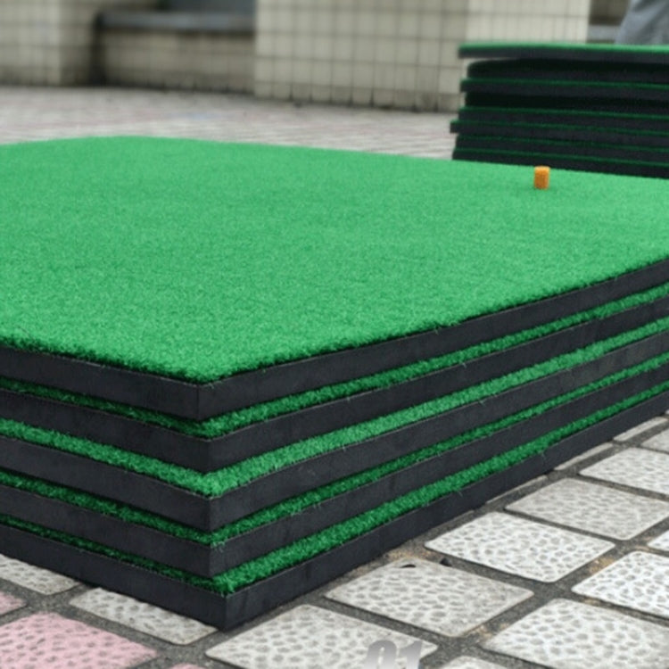 Stacked green turf golf practice mats with black foam layers and corner tee